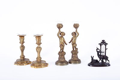 Lot 1247 - A pair of French bronze candlesticks