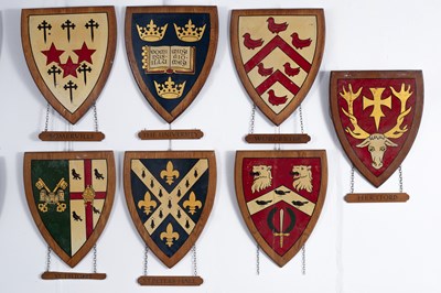 Lot 7 - A collection of painted wood university heraldic shields