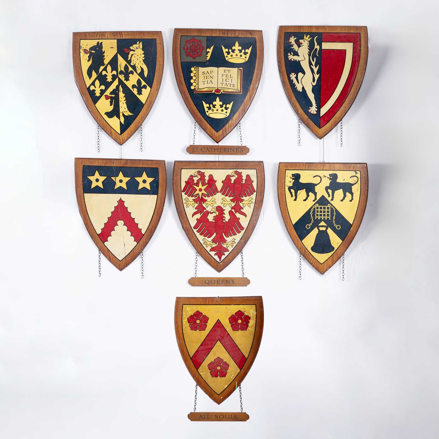 Lot 8 - A collection of painted wood university heraldic shields