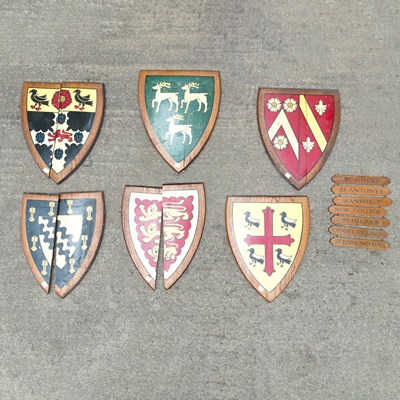 Lot 8 - A collection of painted wood university heraldic shields