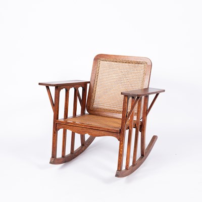 Lot 917 - An American Arts & Crafts oak framed rocking chair