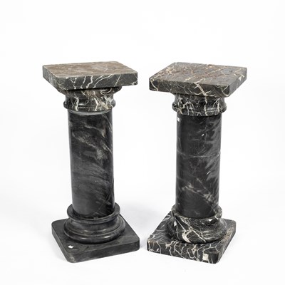 Lot 879 - A pair of black/grey and white veined marble pedestals