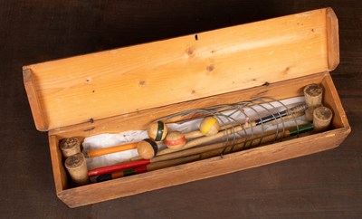 Lot 490 - A miniature croquet set in pine box