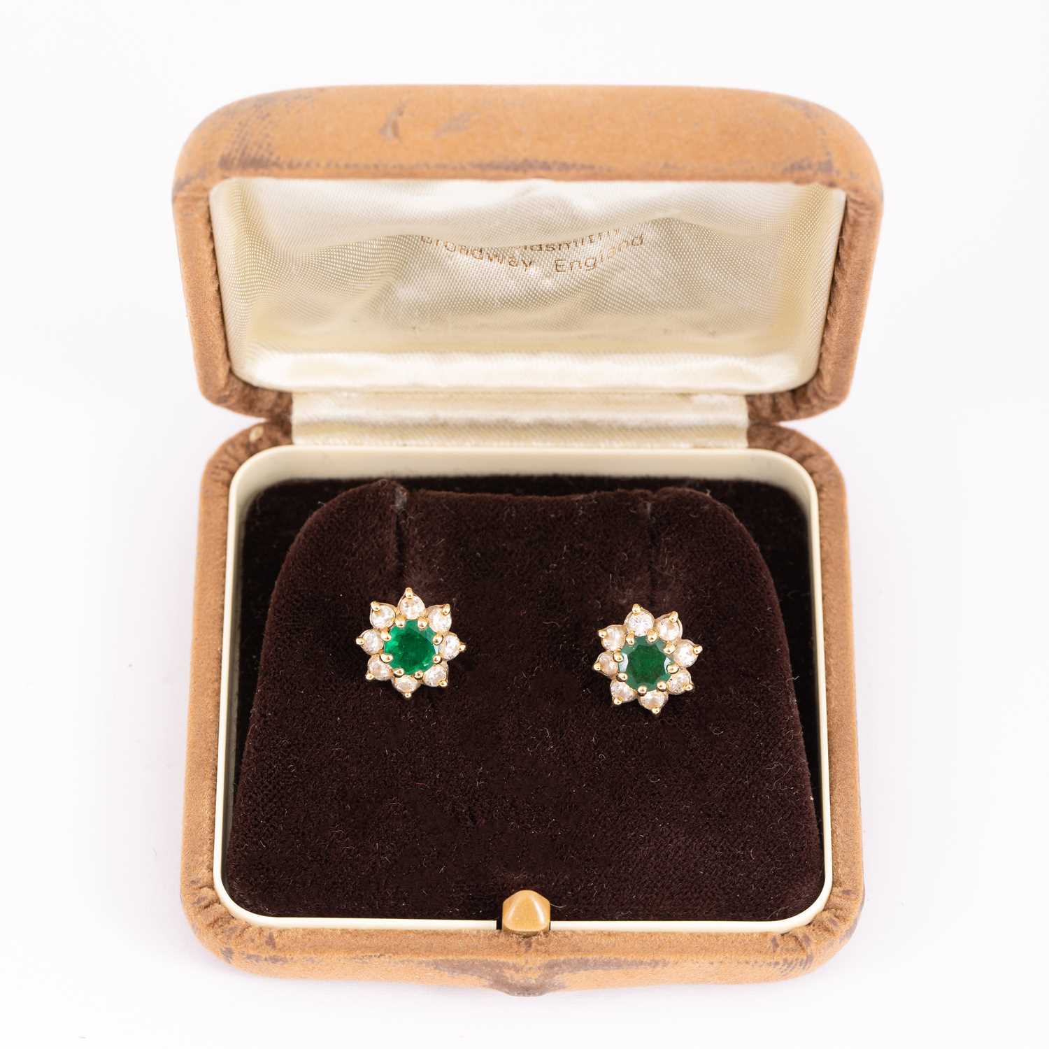 Lot 5 - A pair of emerald and diamond cluster earrings