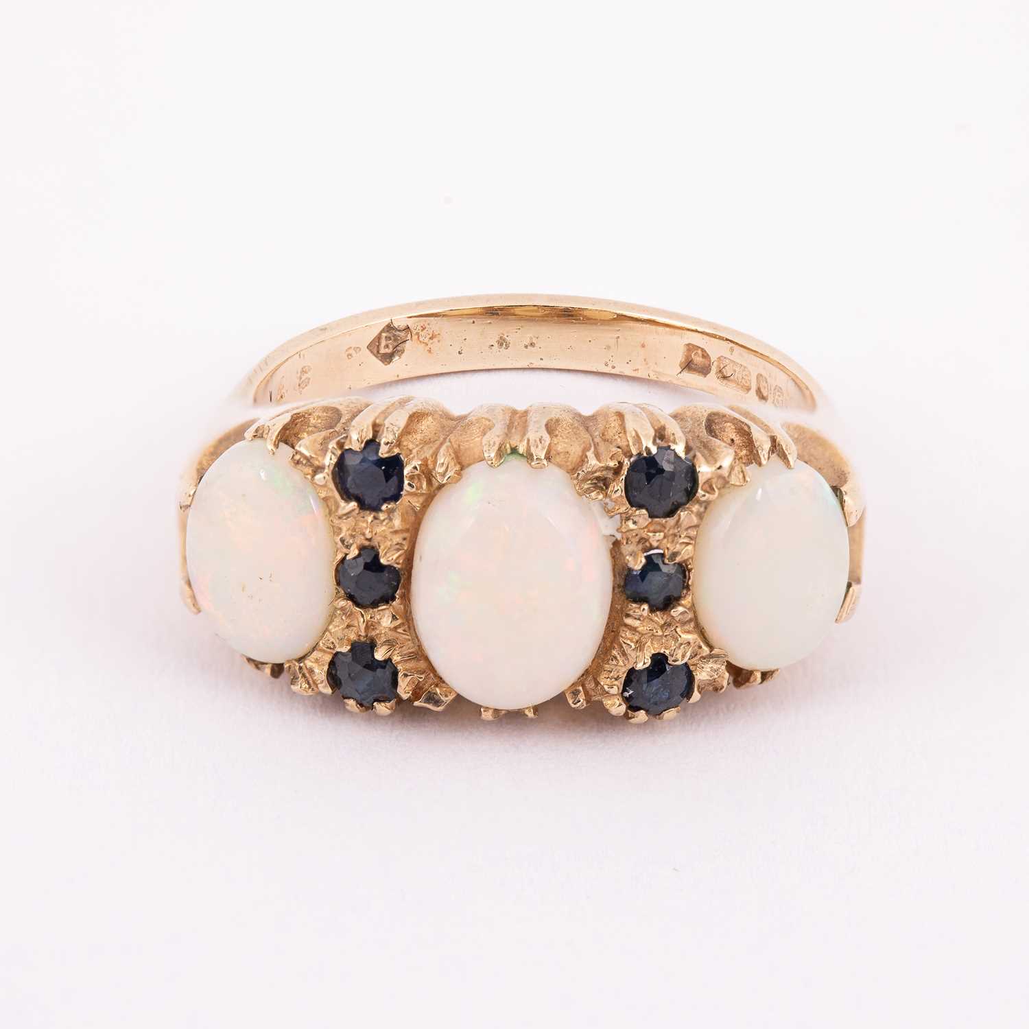 Lot 58 - A 9ct yellow gold opal and sapphire dress ring