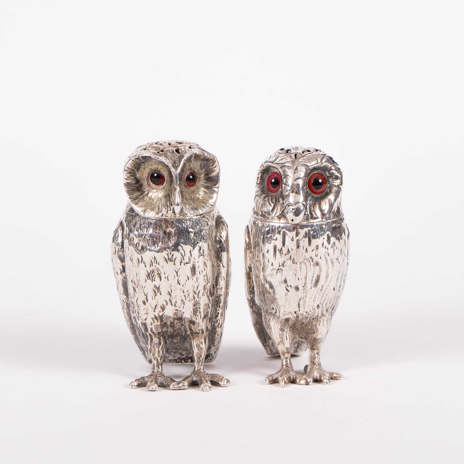 Lot 28 - Two Victorian novelty silver owl pepper pots