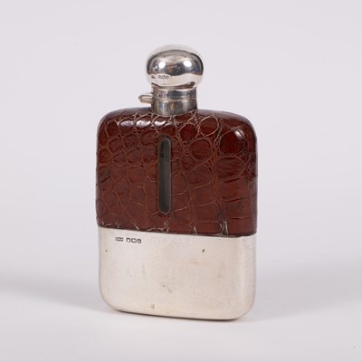 Lot 118 - A silver and leather mounted hip flask