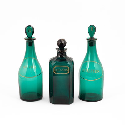 Lot 853 - A pair of green glass mallet-shaped decanters