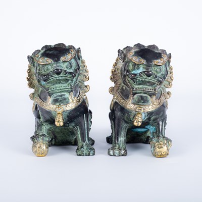 Lot 577 - A pair of patinated bronze Buddhist lions