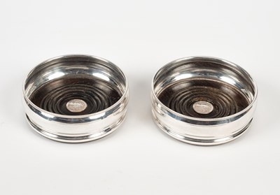 Lot 54 - A pair of silver wine coasters