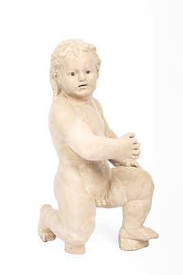 Lot 646 - A carved and painted wooden figure of a putto