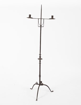 Lot 672 - A wrought iron floor standing tripod pricket candlestick
