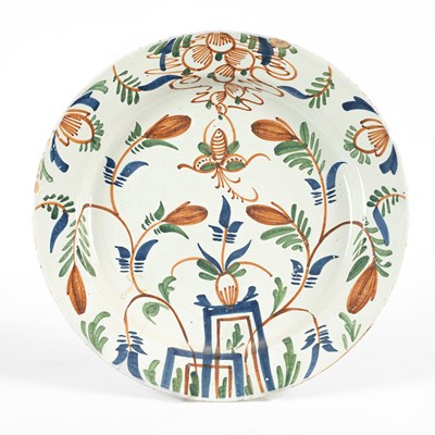 Lot 713 - An English Delftware polychrome charger