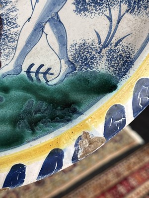 Lot 717 - An English Delftware Adam & Eve blue dash charger