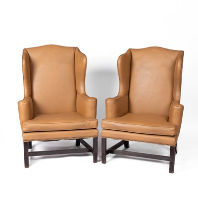 Lot 380 - A pair of George III style upholstered wing armchairs