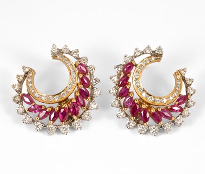 Lot 188 - A pair of yellow and white metal ruby and diamond crescent shaped earrings