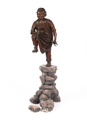 Lot 502 - A Chinese carved wooden sculpture of a worker
