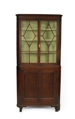 Lot 655 - A George III mahogany floor standing corner cupboard
