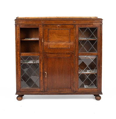 Lot 333 - An Arts & Crafts style oak side or cocktail cabinet