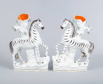 Lot 754 - A pair of Staffordshire pottery zebra spill vases