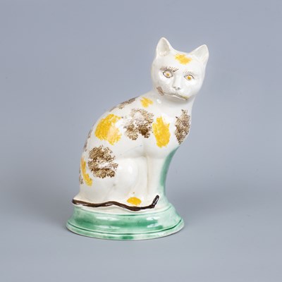 Lot 291 - A Staffordshire pottery figure of a seated cat