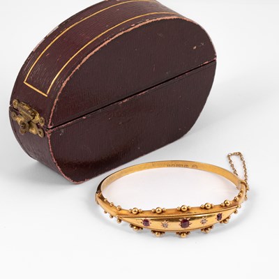 Lot 243 - An Edwardian 15ct gold, ruby and diamond hinged bangle