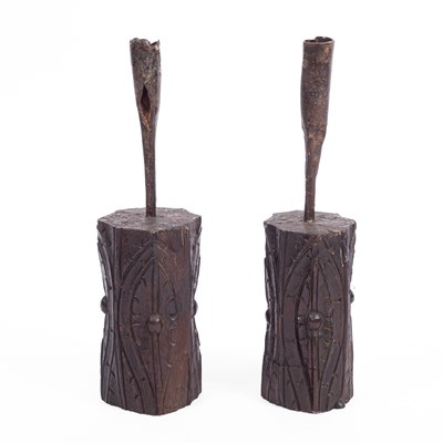 Lot 662 - A pair of carved oak and iron socket candlesticks