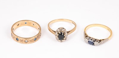 Lot 154 - An 18ct yellow gold sapphire and diamond three-stone ring