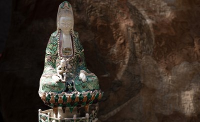 Lot 292 - A Chinese enamel on biscuit figure of Guanyin
