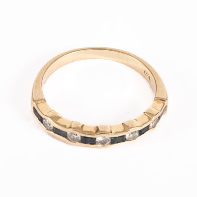 Lot 22 - A diamond and sapphire half hoop ring