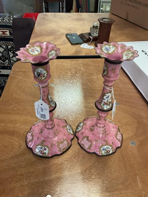 Lot 107 - A pair of Bilston enamel candlesticks