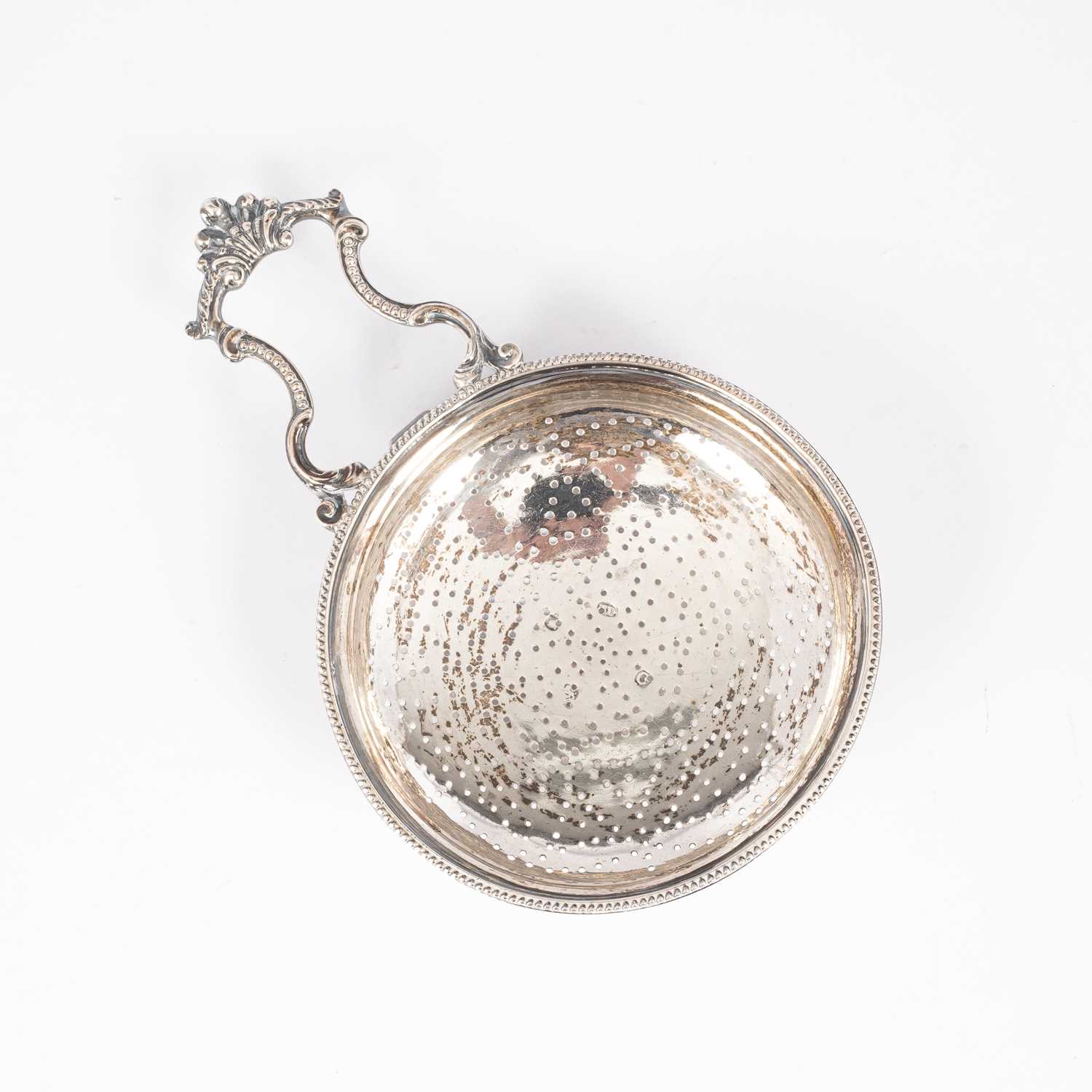 Lot 76 - A George III silver lemon strainer