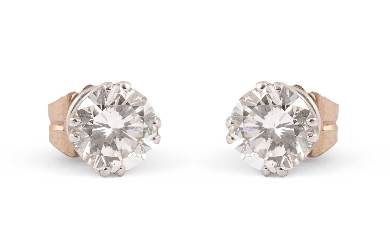 Lot An impressive pair of diamond single stone stud earrings