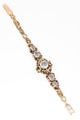 Lot 162 - A yellow metal and aquamarine bracelet