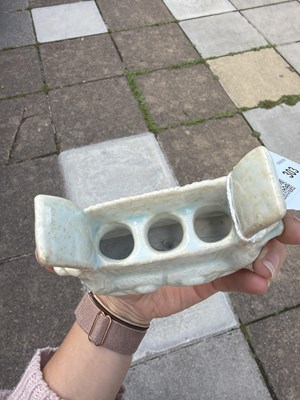 Lot 303 - A small Qingbai porcelain animal form brush holder