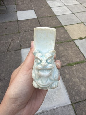 Lot 303 - A small Qingbai porcelain animal form brush holder