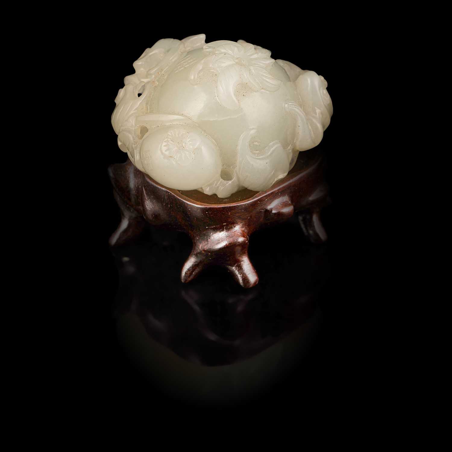Lot 308 - A small pale celadon jade pomegranate carving with a three-legged toad