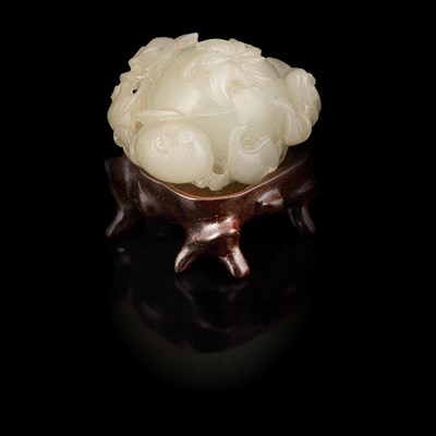 Lot A small pale celadon jade pomegranate carving with a three-legged toad