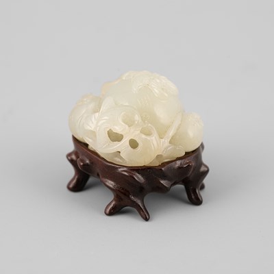 Lot 308 - A small pale celadon jade pomegranate carving with a three-legged toad