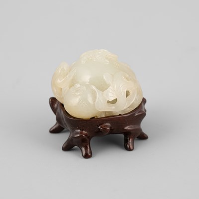 Lot 308 - A small pale celadon jade pomegranate carving with a three-legged toad