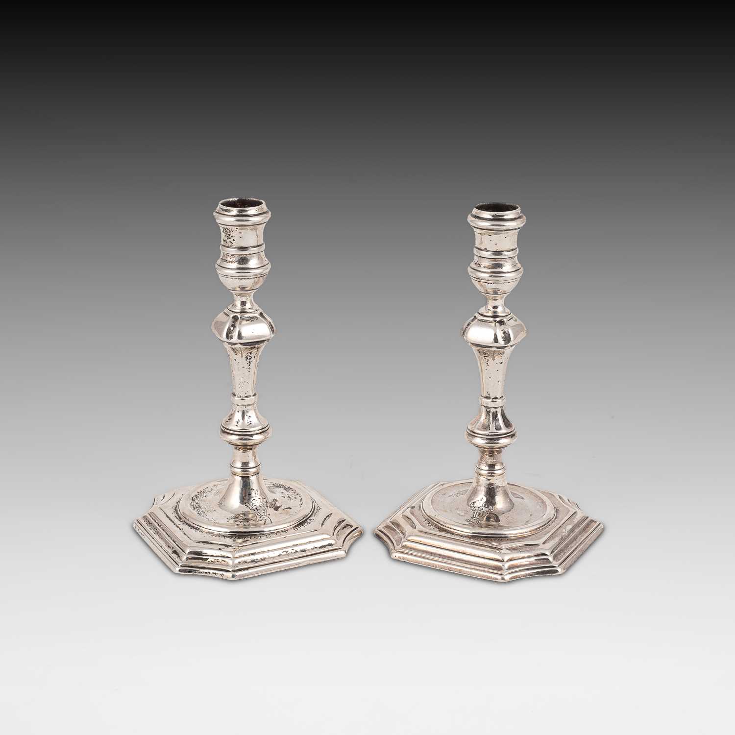 Lot 394 - A pair of George II silver tapersticks
