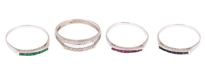 Lot 193 - A white metal sapphire, emerald and ruby stacking ring