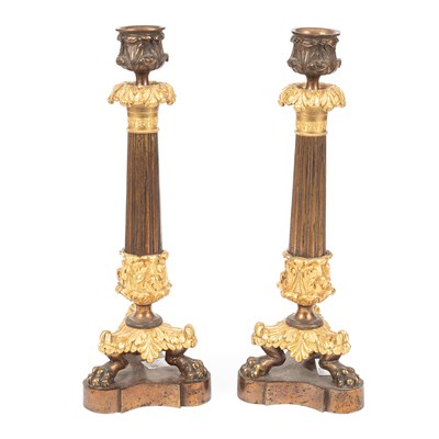 Lot 903 - A pair of Empire style bronze and gilt bronze candlesticks