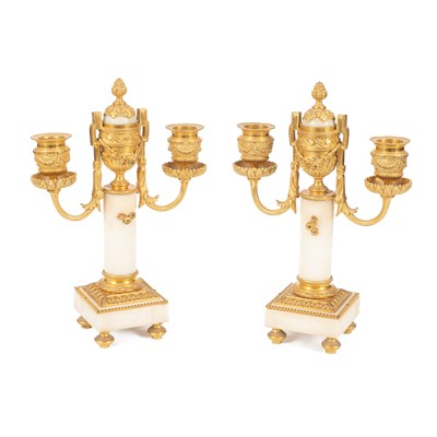 Lot 689 - A pair of Louis XVI style two-branch candlesticks/cassoulets