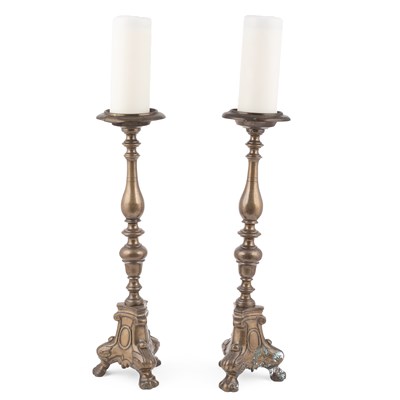 Lot 570 - A pair of brass altar-style candlesticks