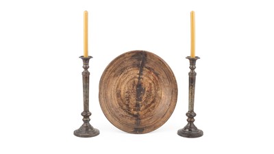 Lot 576 - A pair of patinated brass candlesticks
