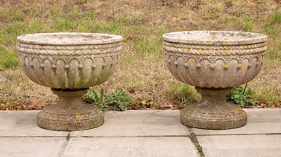Lot 502 - A pair of gadrooned composition stone urns